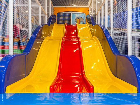 Slides for indoor playground equipment